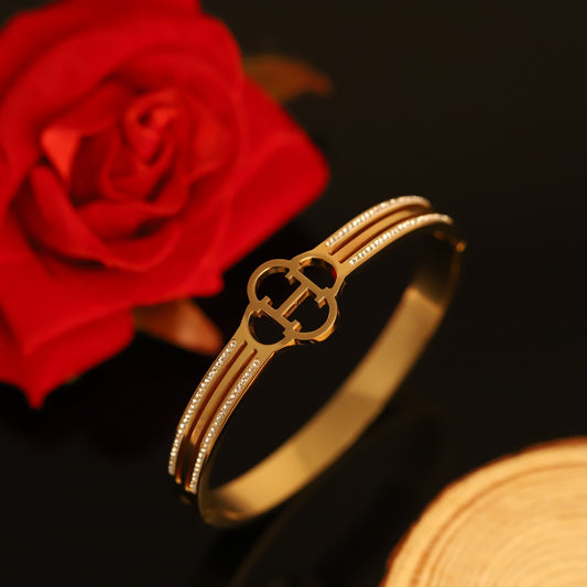 Gold Bangle with Clover & Crystal Accents - Elegant Openwork Bracelet