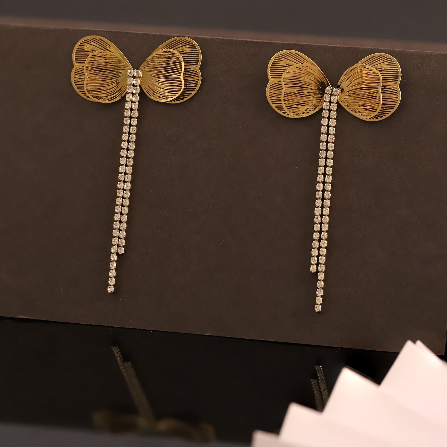 Golden Bow Stud Earrings with Cascading Cubic Zirconia Chains - Glamorous Women's Jewelry