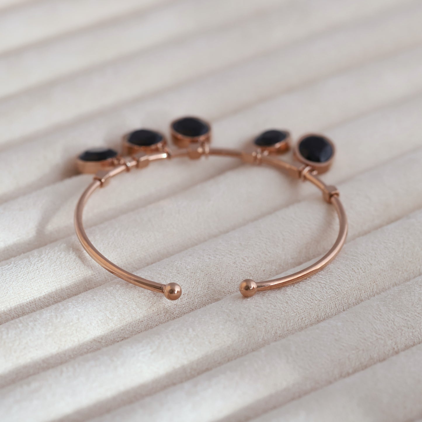 Sleek Rose Gold Plated Kada Bracelet with Black Stone Charms